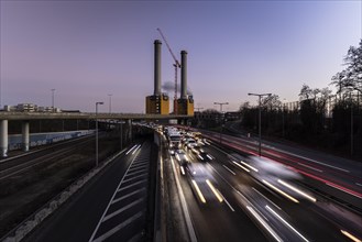Congested traffic on the A100 with a view of the Wilmersdorf combined heat and power plant looms at blue hour in Berlin