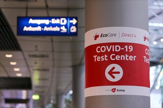 A sign points the way to a COVID-19 test centre at Duesseldorf airport in Duesseldorf