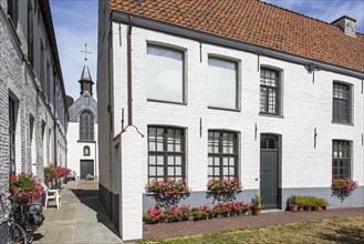 Alley with white beguines' houses and chapel in the Beguinage of Oudenaarde