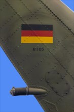 Detail of German Armed Forces helicopter with German flag and blue background