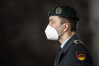 A soldier of the German Armed Forces wearing mouth-nose protection