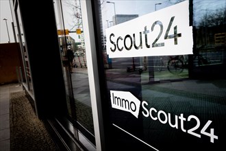 A logo of the companies Scout24 and ImmoScout24 are located at a branch in Berlin