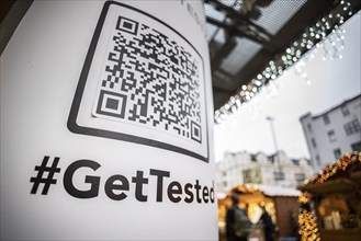A notice saying 'GetTested' is stuck to a shopping centre on Schlossstrasse in Berlin