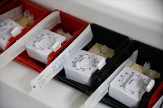 Rapid tests with stopwatches are ready in trays for use in a COVID-19 vaccination and testing centre at Autohaus Olsen in Iserlohn