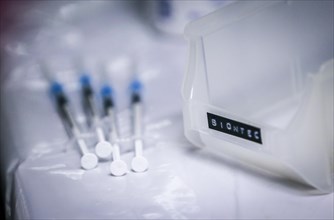 Drawn-up syringes of BioNTech Pfizer vaccine lie next to a tray in a COVID-19 vaccination and testing centre at Autohaus Olsen in Iserlohn