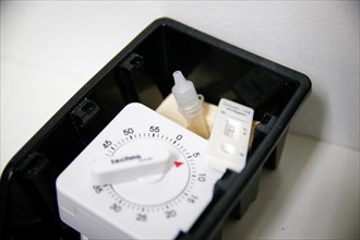 A rapid test with a stopwatch is ready in a tray for use in a COVID-19 vaccination and testing centre at Autohaus Olsen in Iserlohn