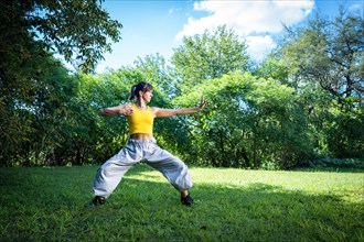 Woman practices Tai Chi outdoor