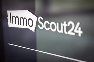 A logo of the ImmoScout24 company is located at a branch in Berlin