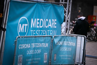 A sign indicates a Medicare COVID-19 testing centre in the old town of Duesseldorf