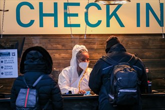 Two people are checked in by an employee of a COVID-19 test centre for a Corona test in the old town of Duesseldorf