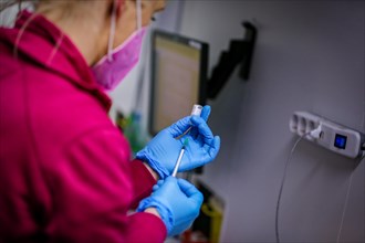 An employee draws up syringes of BioNTech Pfizer vaccine at a COVID-19 vaccination and testing centre at Autohaus Olsen in Iserlohn