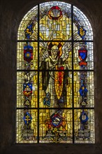 Stained glass window in the Sainte-Mere-Eglise Church depicting Saint Michael and the insignia of various Allied military units that fought in or near the village