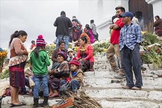 Local people called Mayan K'iche selling flowers on market day in front of the church Iglesia de Santo Tomas in Chichicastenango