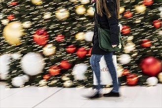 People stand out against Christmas decorations in a shopping centre on Schlossstrasse in Berlin