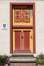 Historical wooden door with painted carvings