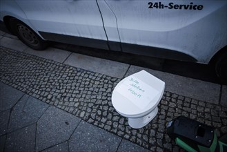 A toilet bowl stands on a pavement in Berlin Mitte. Berlin