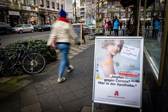 A poster at a pharmacy advertises the possibility to get vaccinated at pharmacies in Duesseldorf