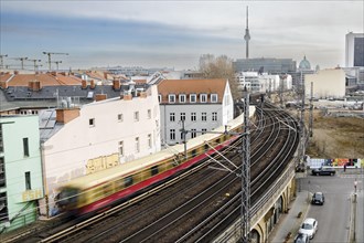 An S-Bahn train runs over the Stadtbahn in Berlin Mitte near Friedrichstrasse station. The television tower can be seen in the background. Berlin