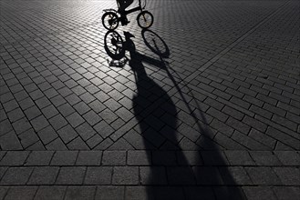 The silhouette of a cyclist stands out in Berlin