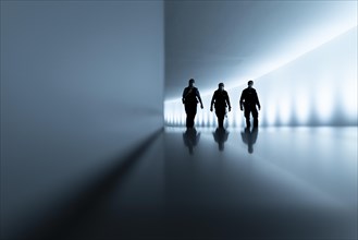 The silhouettes of three police officers stand out in the passageway between the Reichstag building and the Paul Loebe House in Berlin