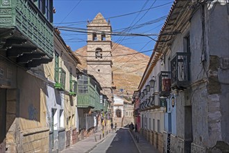 Street with colonial houses and bell tower of the San Francisco of Potosi Temple and Convent in the city Potosi