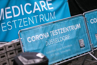 A sign indicates a Medicare COVID-19 testing centre in the old town of Duesseldorf