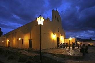 Churchgoers going to church in the evening at Cachi
