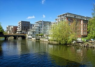 Retirement home and modern residential buildings on the river Weisse Elster