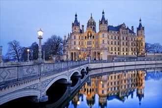 Schwerin Castle with the castle bridge to the castle island in the evening