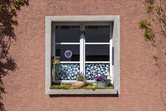 Window with decoration on the window sill in the old town of Radolfzell on Lake Constance