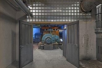 View into a hall with generator of a former paper factory