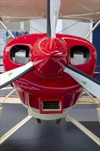 The front part of the aircraft with the propeller with red engine cowling and engine cooling vents