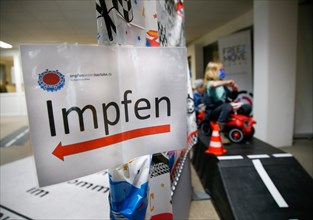 A sign with the words vaccinate is displayed on a wall at a COVID-19 vaccination and testing centre at Autohaus Olsen in Iserlohn