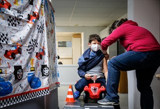 A boy is vaccinated by a doctor with the BioNTech Pfizer children's vaccine at a COVID-19 vaccination and testing centre at Autohaus Olsen in Iserlohn