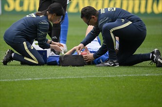 Attendants treat bleeding head wound after header duel of Finn Ole Becker TSG 1899 Hoffenheim