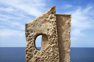 Stone sculpture in front of the coast
