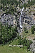 Waterfall and shepherd's house and stables in the Valsavarenche Valley in the Gran Paradiso National Park