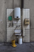 Hand basin with instantaneous water heater in a factory hall in a former paper factory