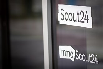 A logo of the company ImmoScout24 and Scout24 are located at a branch in Berlin