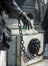 Detail photo of the chained warriors at the base of the equestrian statue of Frederick William of Brandenburg