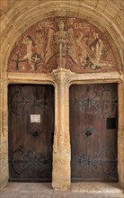 Old door and mosaic in the portal of the Saint Michael church