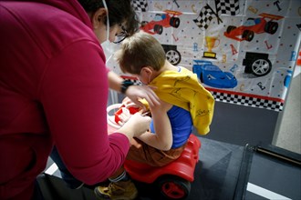 A boy is vaccinated by a doctor with the BioNTech Pfizer children's vaccine at a COVID-19 vaccination and testing centre at Autohaus Olsen in Iserlohn