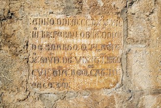Latin inscription on outer wall of the Cathedrale Notre-Dame de Saint-Bertrand-de-Comminges cathedral