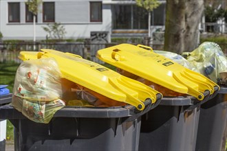 Yellow bins filled with yellow bags for plastic waste with lid