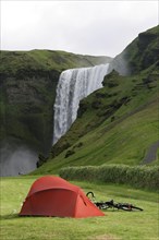 Hiker's tent and touring bicycle near the Skogafoss