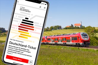 Germany ticket D-ticket or 49 euro ticket on a mobile phone with regional train Regional train photo montage in Aitrang