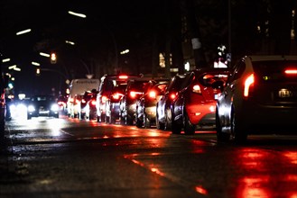 Brake lights of car stand out in the evening in Berlin