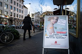 A poster at a pharmacy advertises the possibility to get vaccinated at pharmacies in Duesseldorf