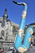 Saxophone and the Collegiate Church of Notre-Dame along the river Meuse at Dinant