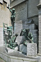 Sculpture group showing medieval labourers and stone carvers in front of the Cathedral of Our Lady in Antwerp